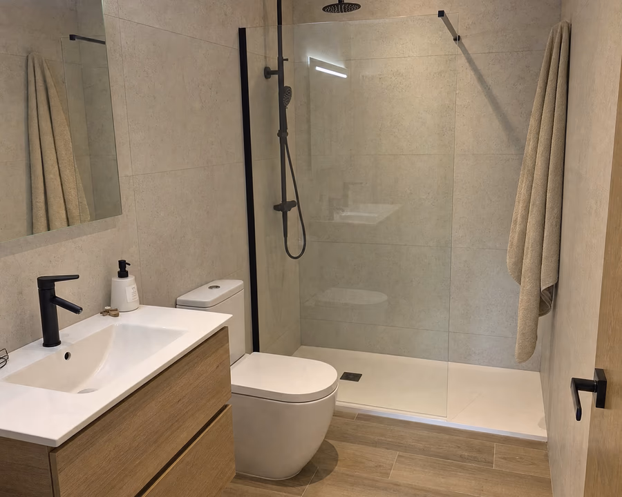 Walk-in shower with white ceramic tiles